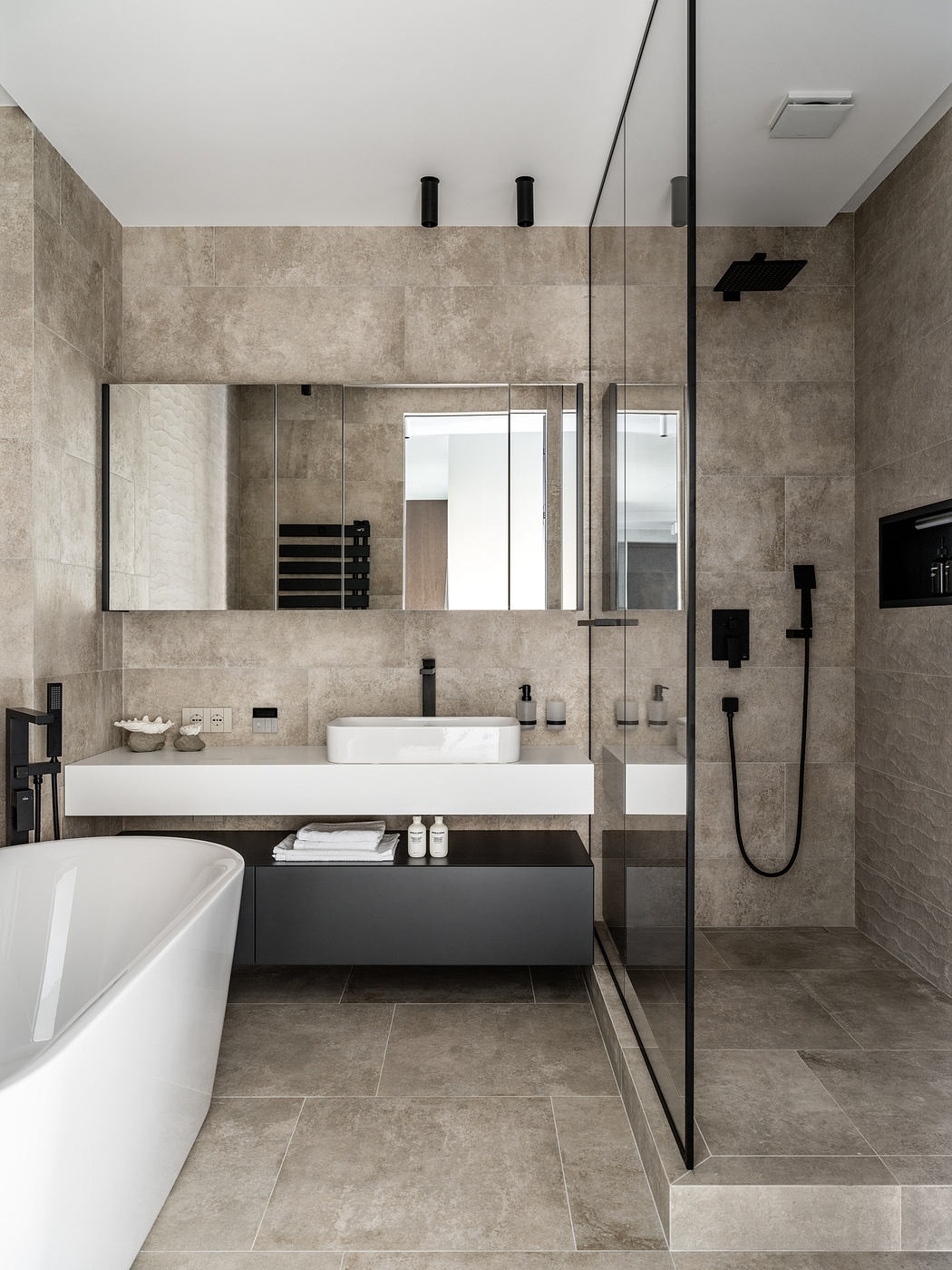 A modern bathroom with clean lines, a floating vanity, and a glass-enclosed shower.
