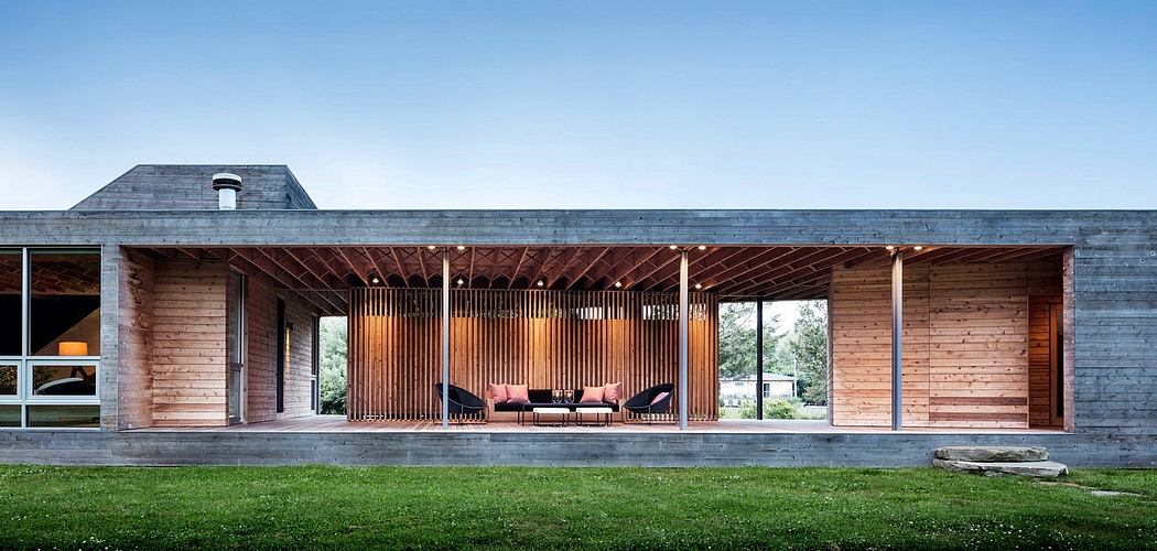 Expansive wooden beams and floor-to-ceiling windows create an open, inviting space.