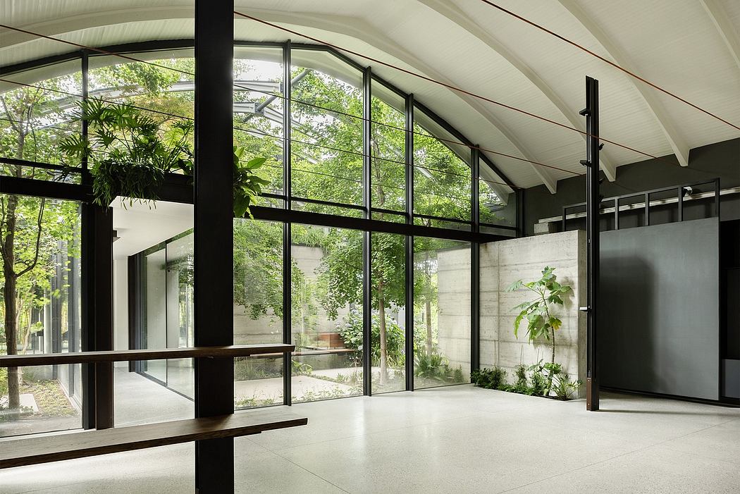 A spacious modern indoor space with floor-to-ceiling glass walls, minimalist style.