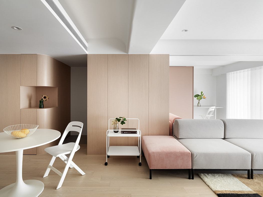 A modern, minimalist living space with neutral tones, clean lines, and functional furniture.