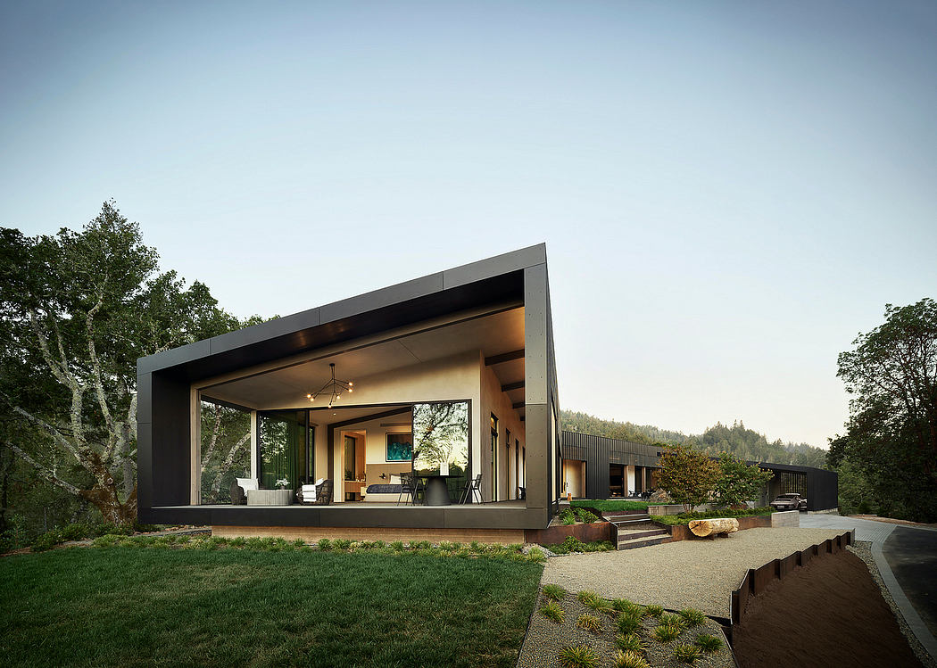 Modern, sleek house with large windows, covered patio, and landscaped surroundings.