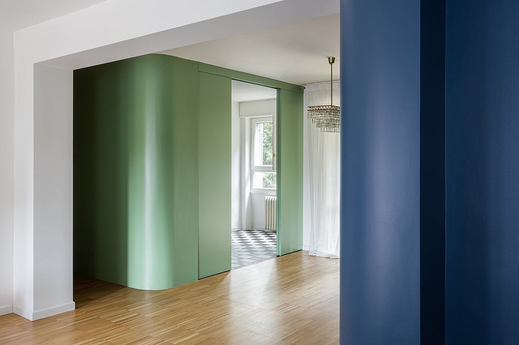 A modern, minimalist interior with a vibrant green sliding door and blue accent wall.