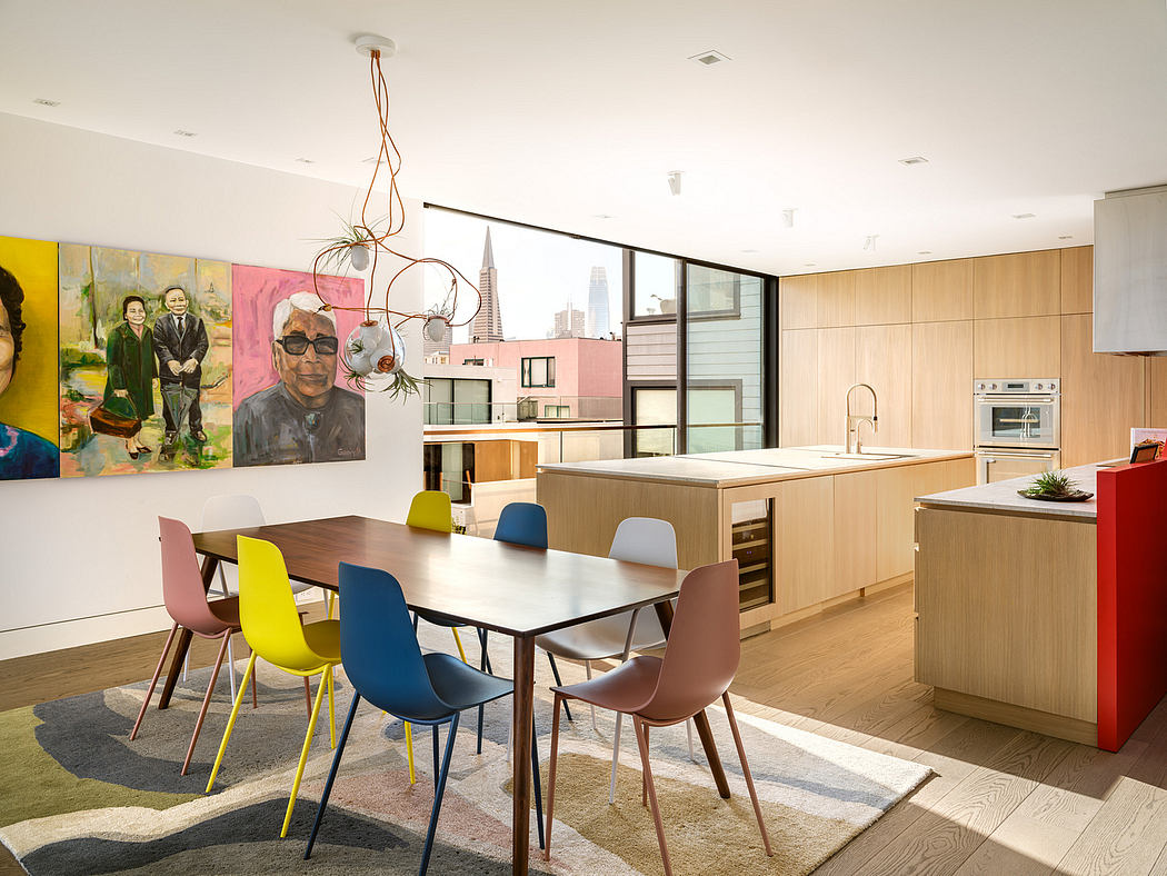 The image depicts a modern, open-concept kitchen and dining area with vibrant colors, sleek furnishings, and a cityscape view.