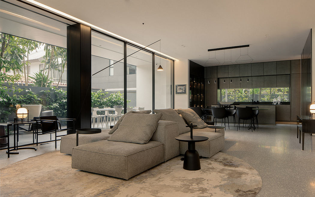 Expansive open-concept living space with sleek modern furnishings, large windows, and lush greenery.