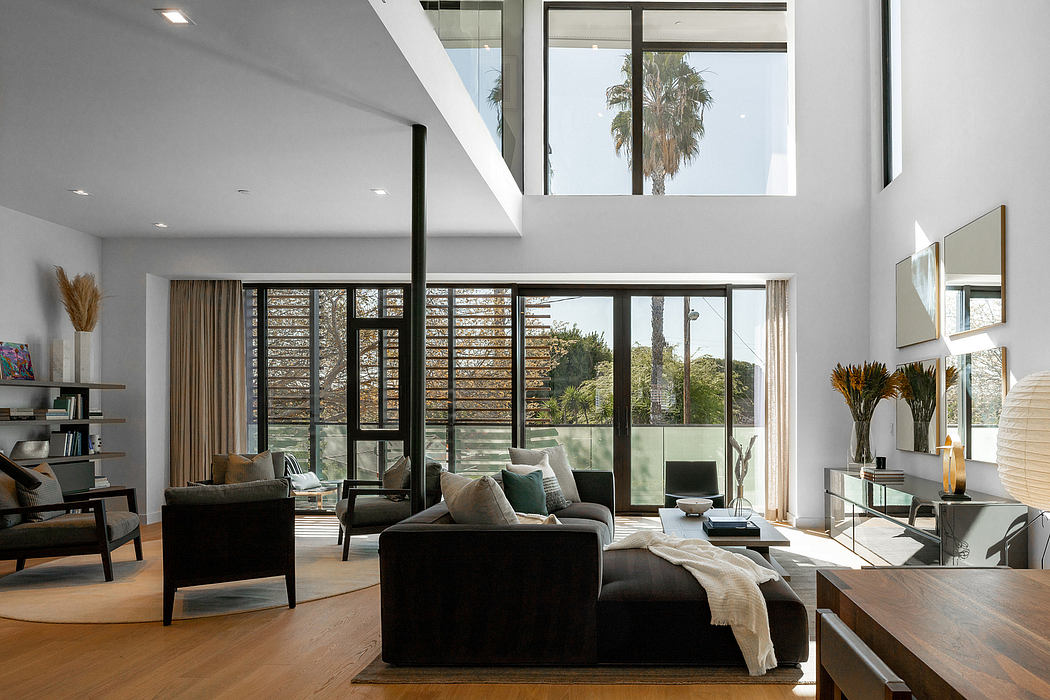 Bright, open-concept living space with large windows, modern furniture, and natural textures.