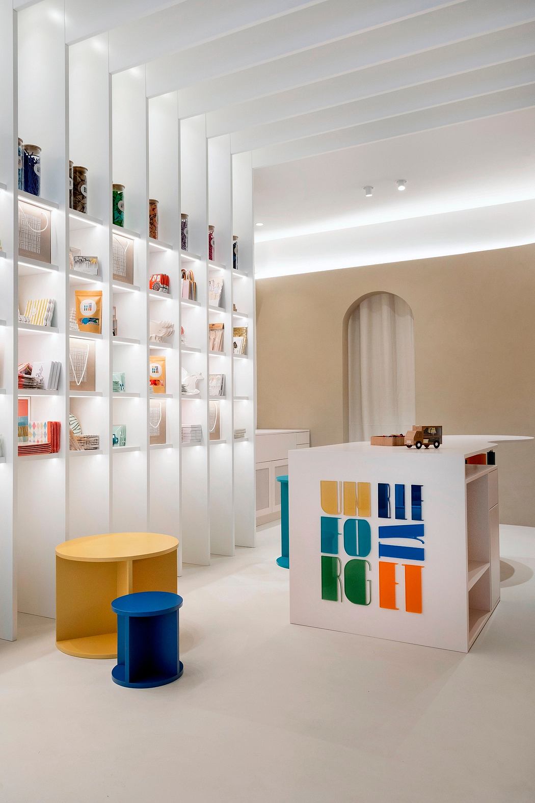 Modern interior with minimalist shelving, colorful storage units, and geometric seating.