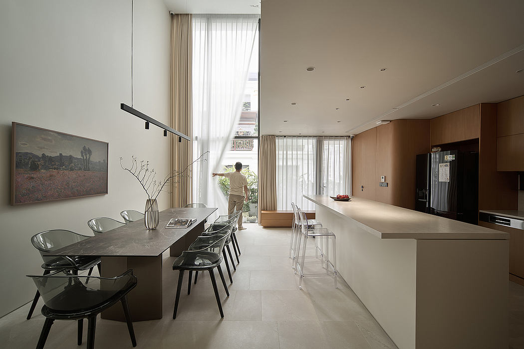 Sleek, modern kitchen with a minimalist dining area and large windows offering natural light.