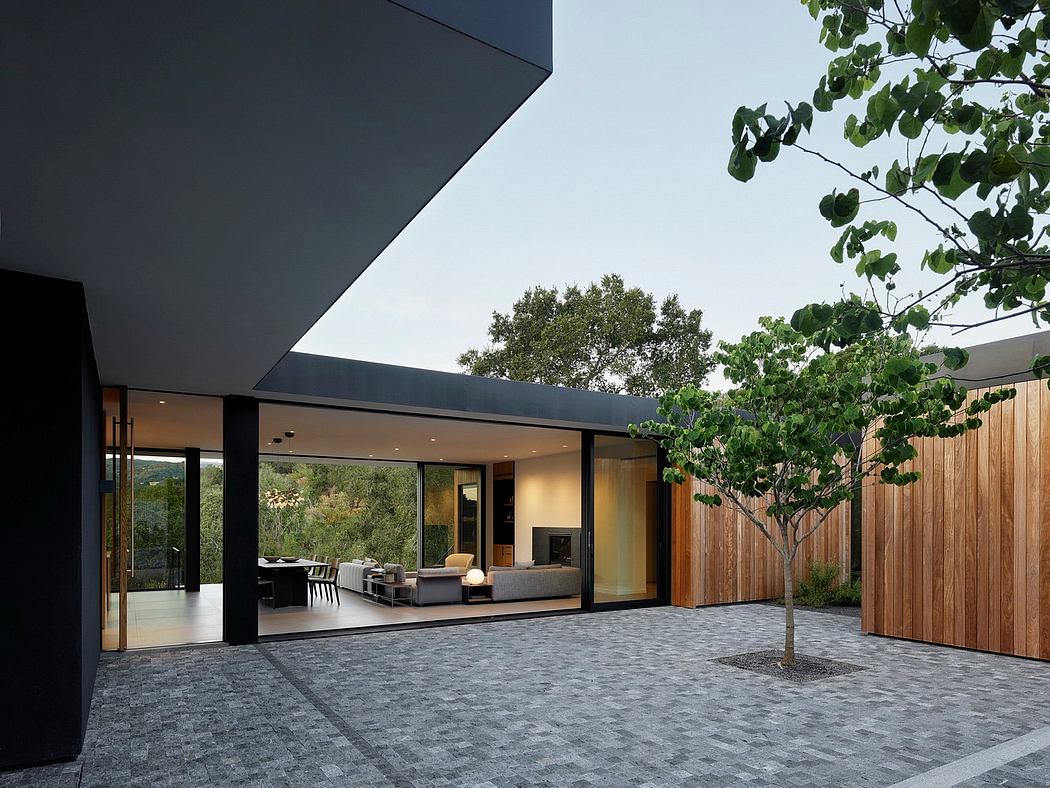 Sleek modern architecture with glass walls overlooking a landscaped courtyard.