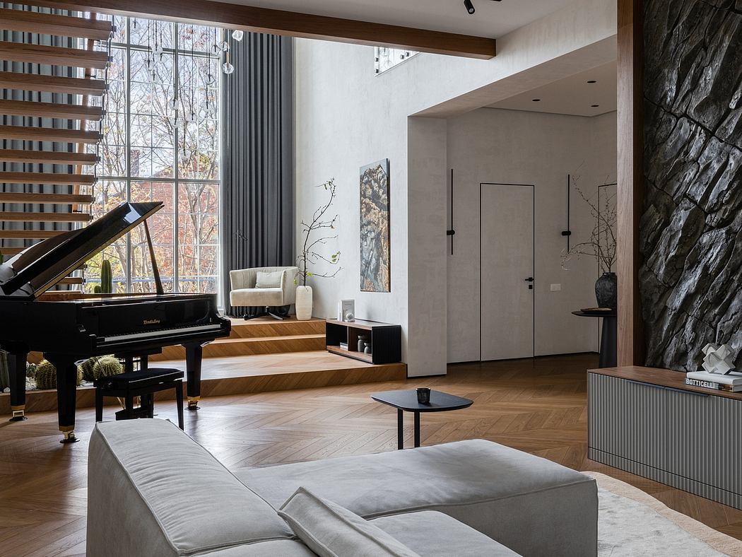Elegant, open-concept living space with grand piano, stone walls, and modern furnishings.