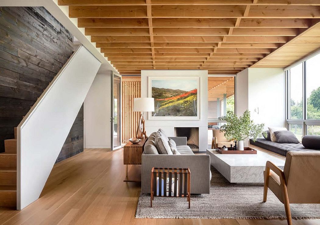Rustic wood beams, warm tones, and contemporary furnishings create a cozy, inviting space.