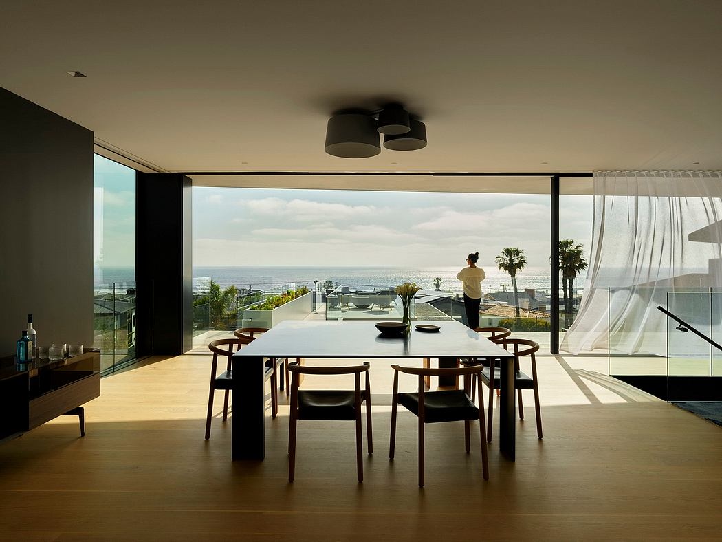 Sleek, modern dining room with stunning panoramic views and minimalist furnishings.