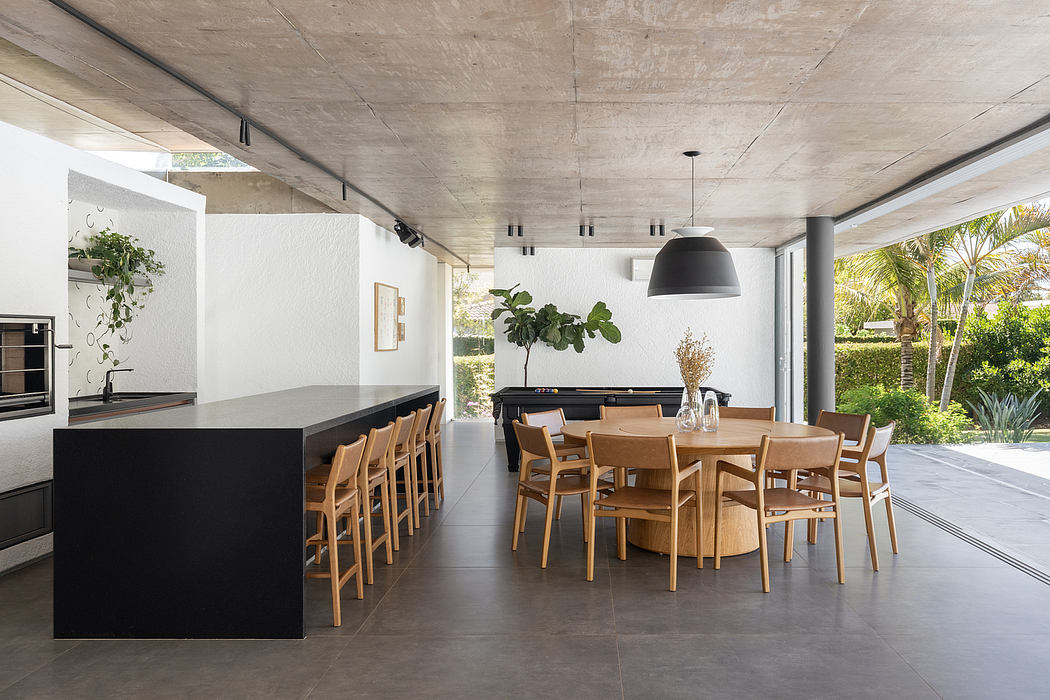 Spacious open-plan living area with minimalist concrete and wood elements.