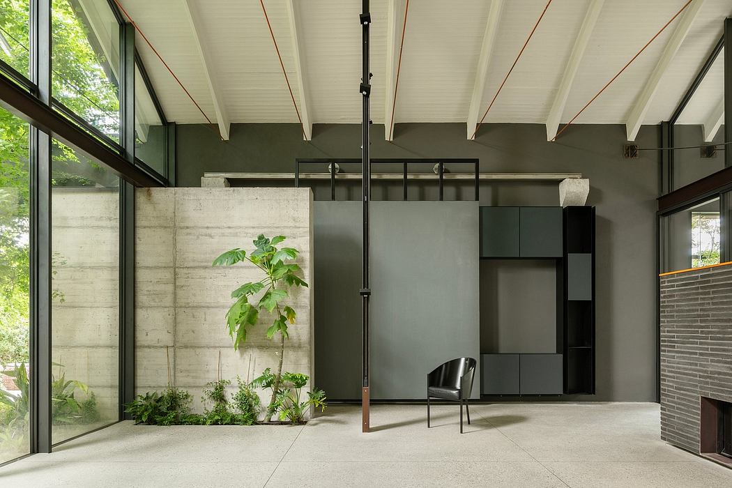 An airy, modern interior with concrete walls, wood-beamed ceiling, and integrated greenery.