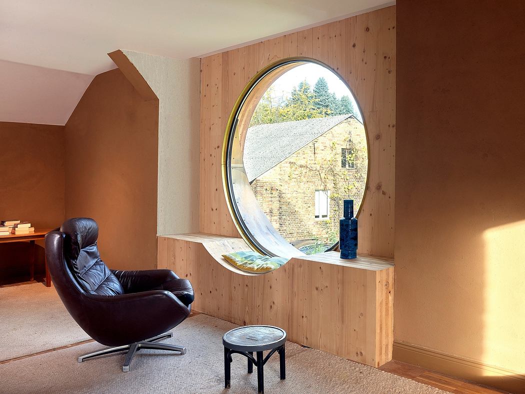 Cozy room with round window showcasing outdoor scenery, minimalist furnishings.