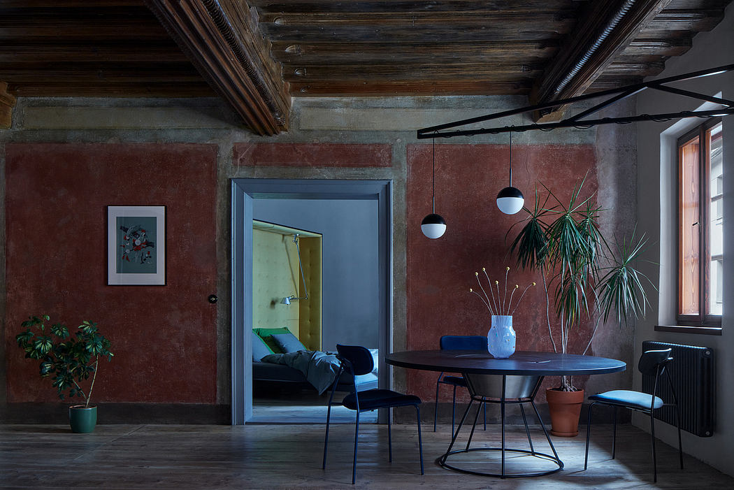 Rustic wooden beams, moody lighting, and modern furniture create a cozy, eclectic space.