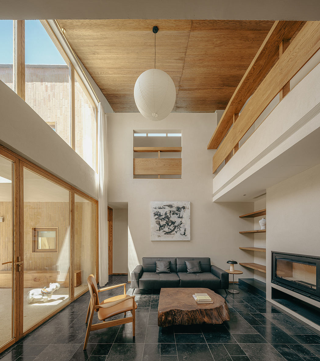 Warm, modern interior with wood-paneled ceiling, built-in shelves, and large windows.