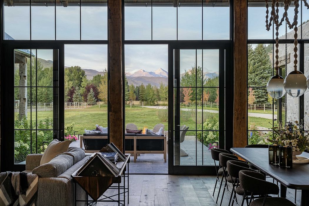 Spacious open-plan interior with floor-to-ceiling windows showcasing scenic mountain views.
