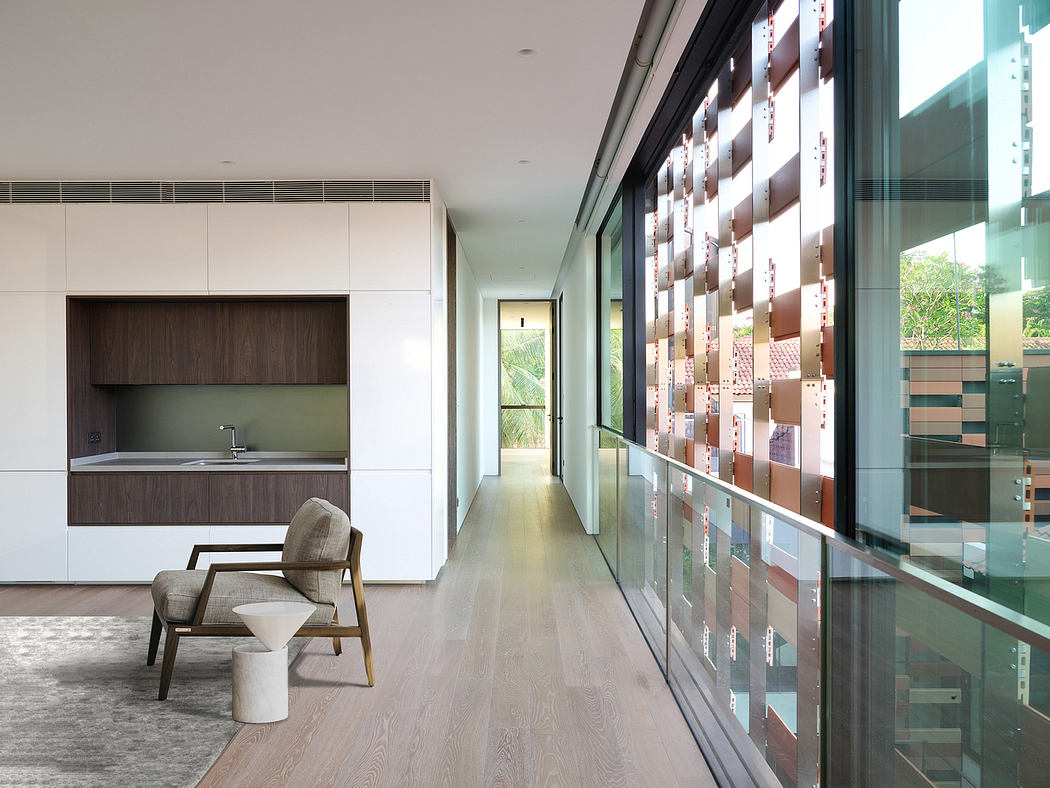 Sleek, modern kitchen with floor-to-ceiling glass walls offering natural light and views.