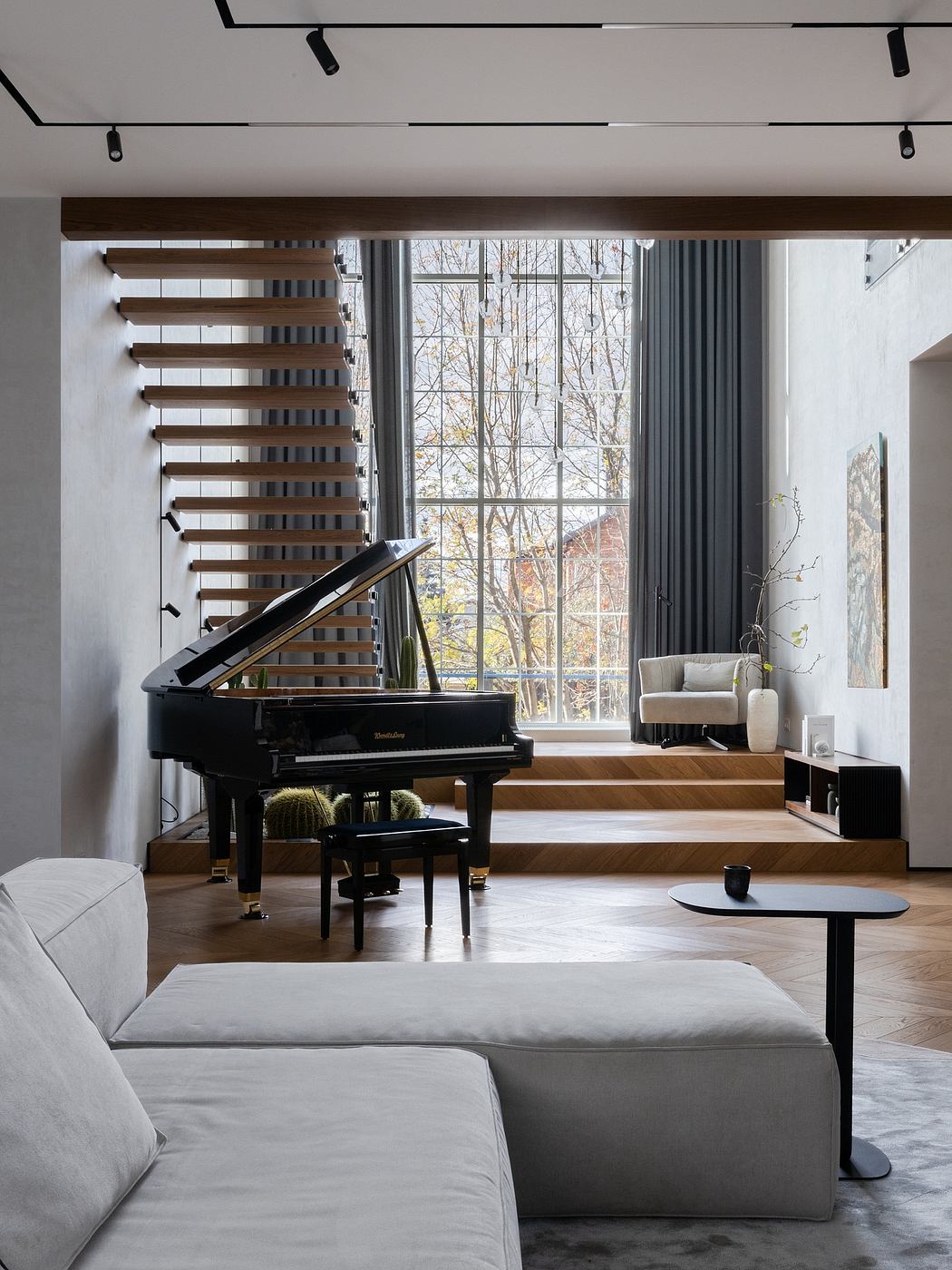 A modern living room with a grand piano, wood accents, and floor-to-ceiling windows showcasing the outdoor scenery.