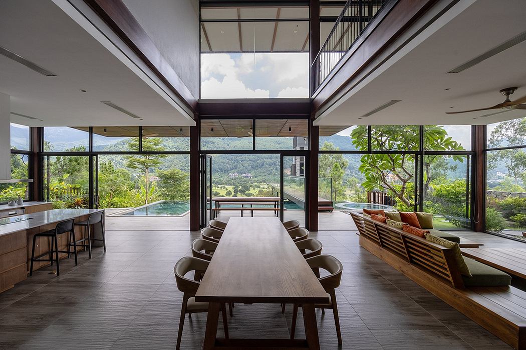 Spacious open-plan interior with large windows offering panoramic mountain views.