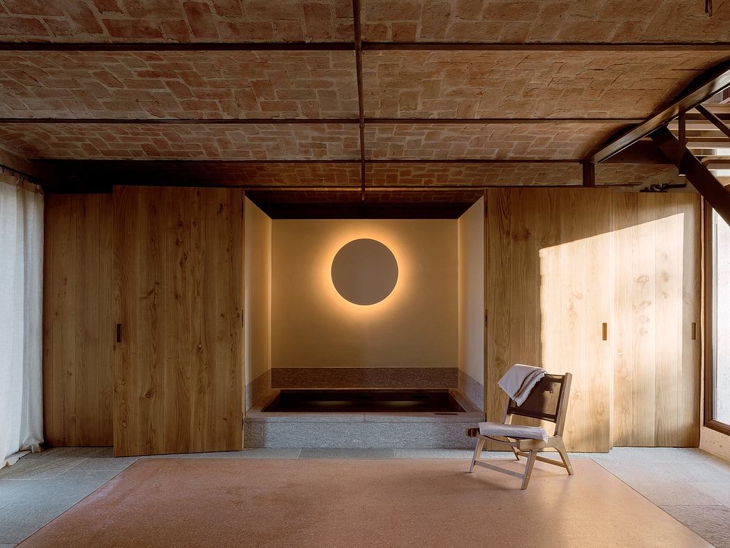 A spacious, minimalist room with wood paneled walls, stone ceiling, and circular wall feature.