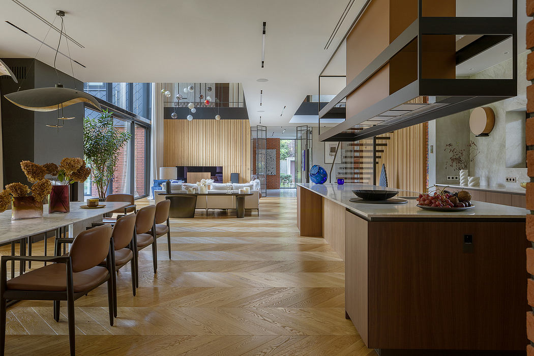 Spacious open-concept living area with wood floors, recessed lighting, and modular furniture.