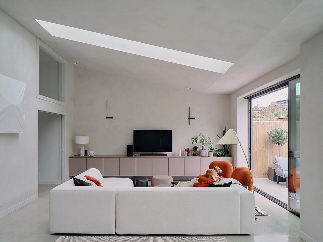 Spacious open-plan living area with sleek, modern furniture and floor-to-ceiling windows.