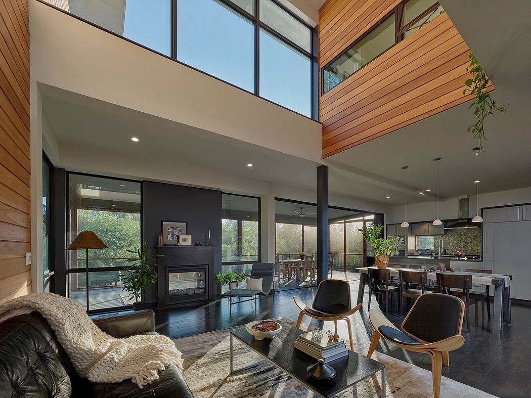 Spacious, modern living room with high ceilings, large windows, and wooden accents.