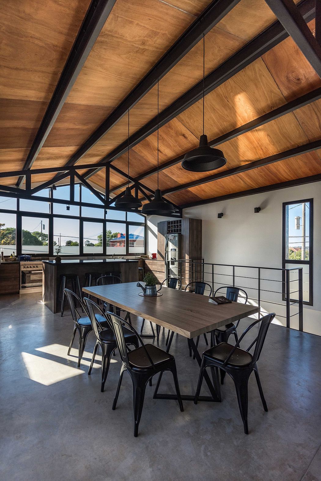 Rustic wooden ceiling beams, industrial-chic lighting, and a minimalist dining space.