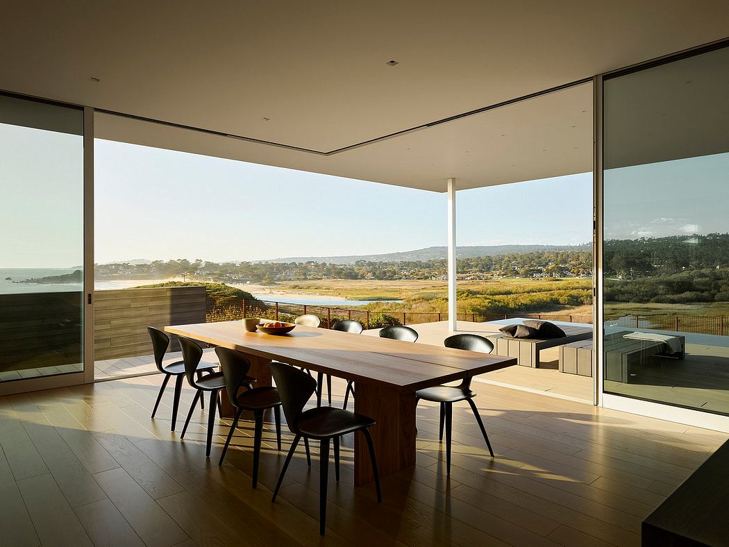 Expansive dining area with sweeping ocean views, contemporary furnishings, and floor-to-ceiling windows.