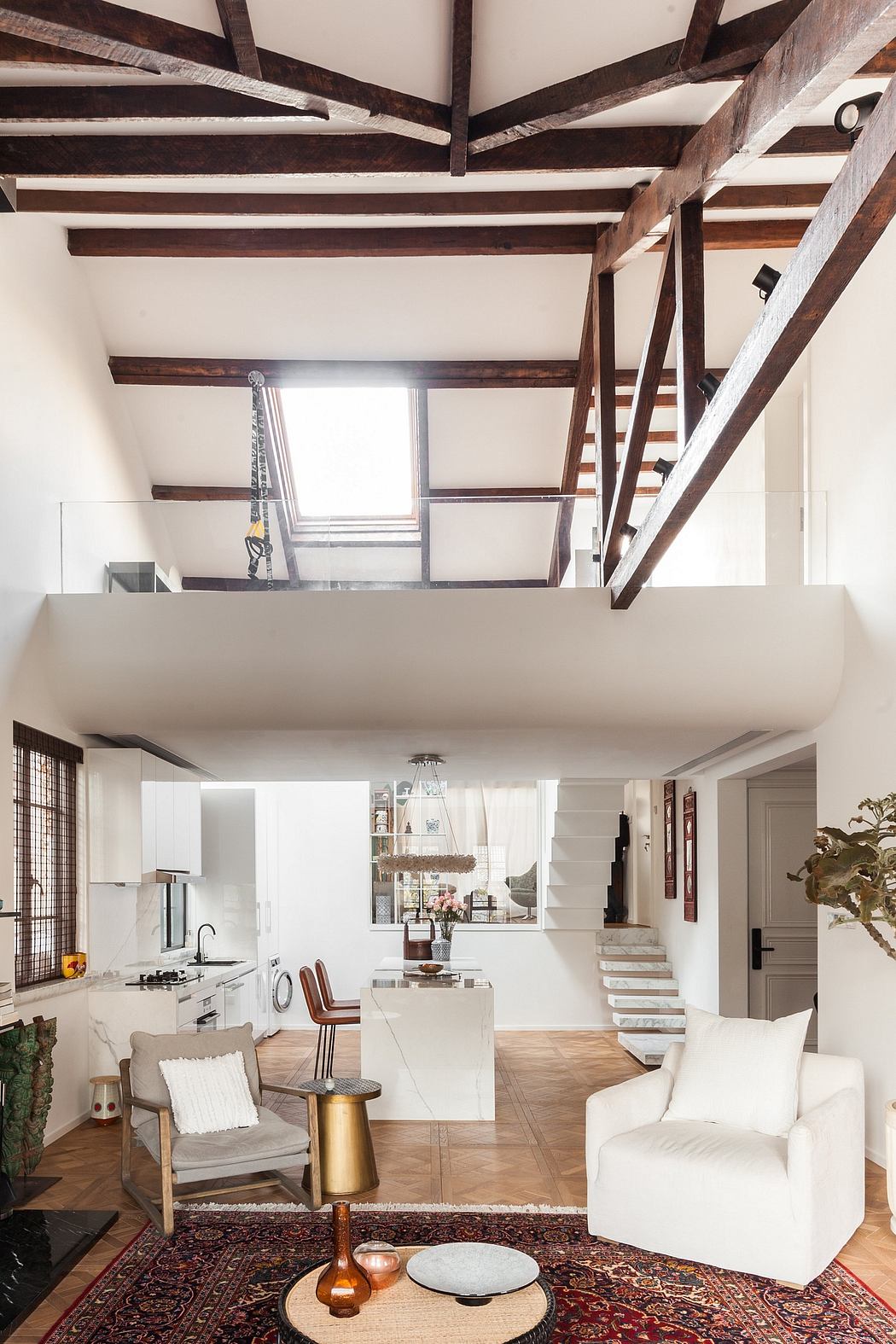 Open-concept living space with exposed wooden beams, white walls, and a blend of modern and rustic elements.