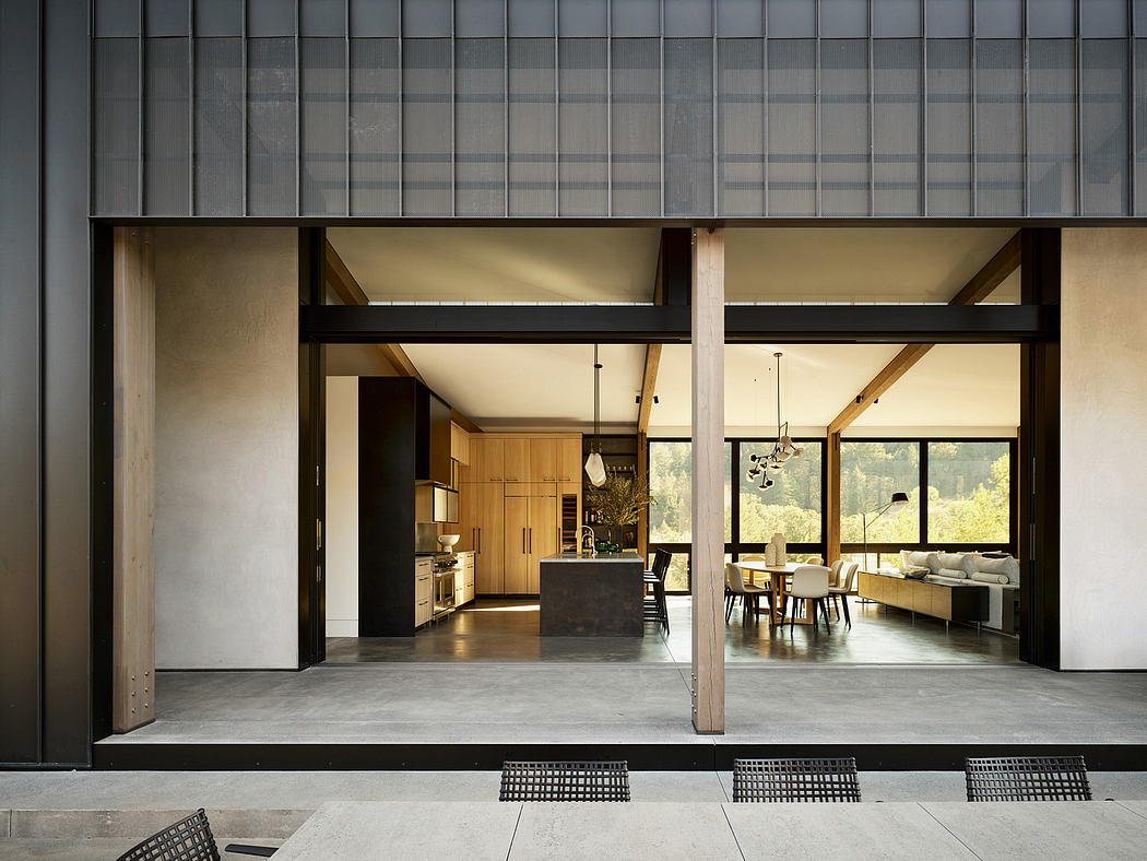 A modern, open-plan interior with wooden and concrete elements, large windows offering scenic views.