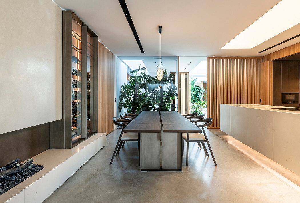 A modern, spacious dining area with a wooden table, minimalist chairs, and lush greenery.
