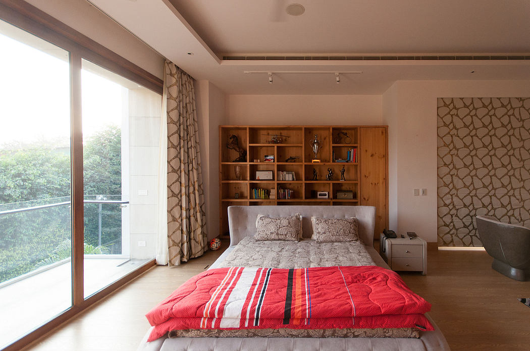 Cozy bedroom with wooden built-in shelves, patterned curtains, and large windows.