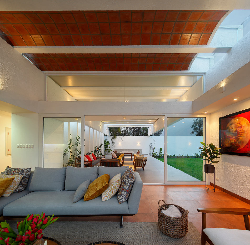 Spacious open-concept living room with brick ceiling, glass walls, and lush outdoor view.