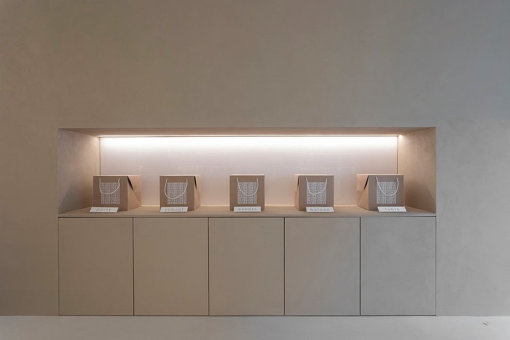 Minimalist shelving unit with labeled wire mesh baskets and soft lighting along the top.