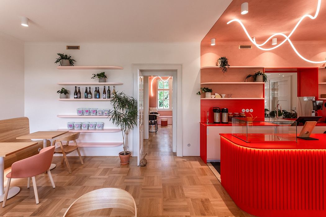 Vibrant modern kitchen with sleek red counter, ambient lighting, and shelved decor.
