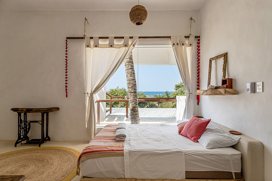 Cozy bedroom with tropical views, woven pendant light, and rustic furnishings.