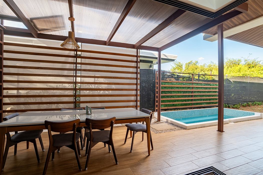 Covered deck with wooden beams, tile floor, and swimming pool visible through slatted screens.