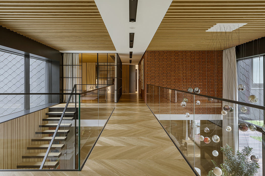 Striking modernist interior featuring wood paneling, glass railings, and spherical lighting.
