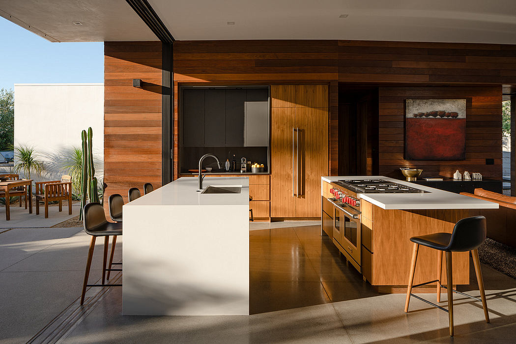 Spacious kitchen with wood paneling, island counter, and high-end appliances in modern home.