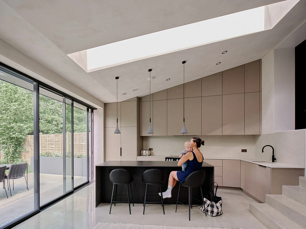 A modern, minimalist kitchen with sleek cabinetry, pendant lights, and sliding glass doors.