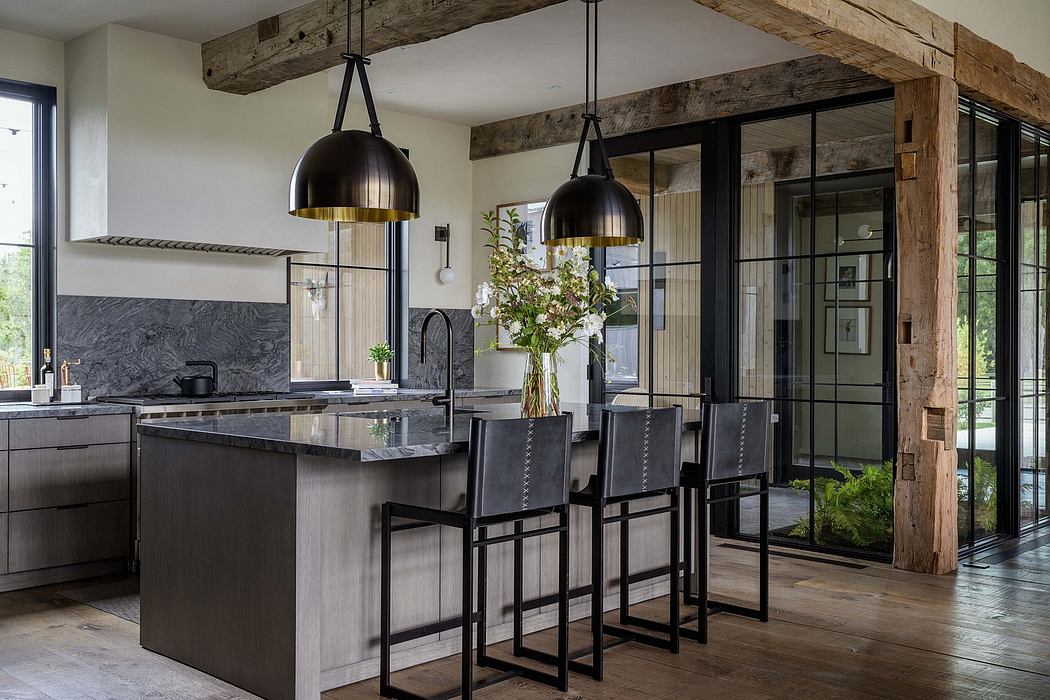 Modern kitchen with rustic wooden beams, black pendant lamps, and sleek gray cabinetry.