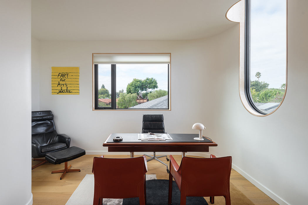 A modern, minimalist office space with a large window, leather chairs, and a sleek desk.