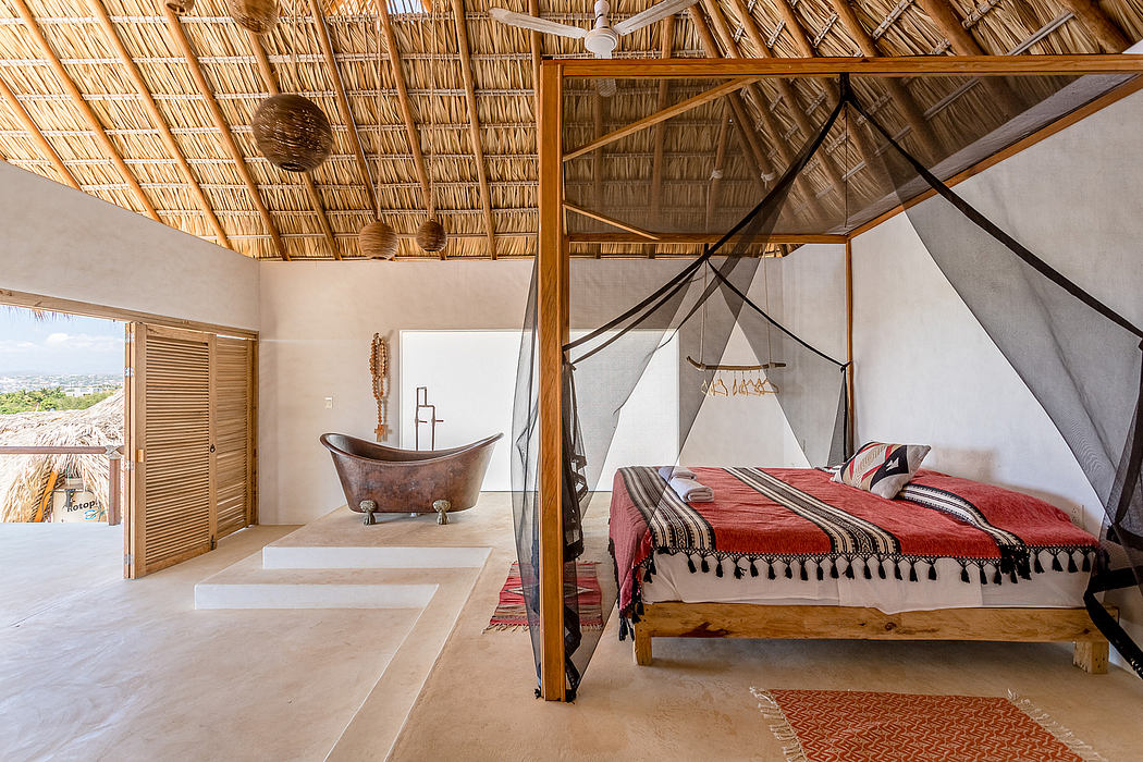 Rustic and inviting bedroom with thatched roof, wooden furnishings, and bathtub.
