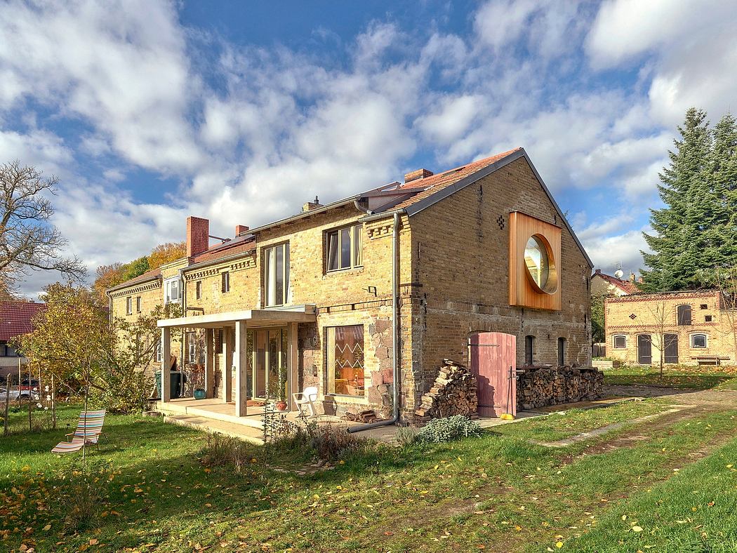 A charming stone building with ornate architectural details, surrounded by lush greenery.