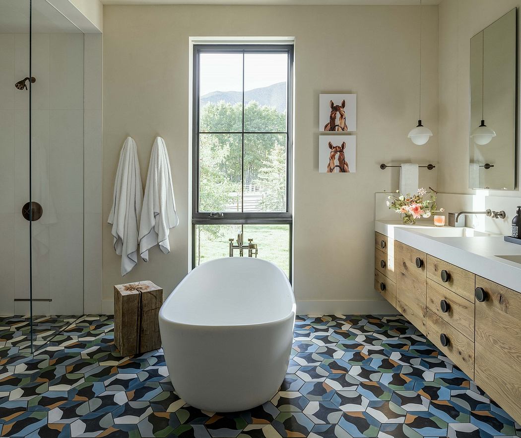 Airy bathroom with freestanding tub, patterned tiled floor, and rustic wood vanity.