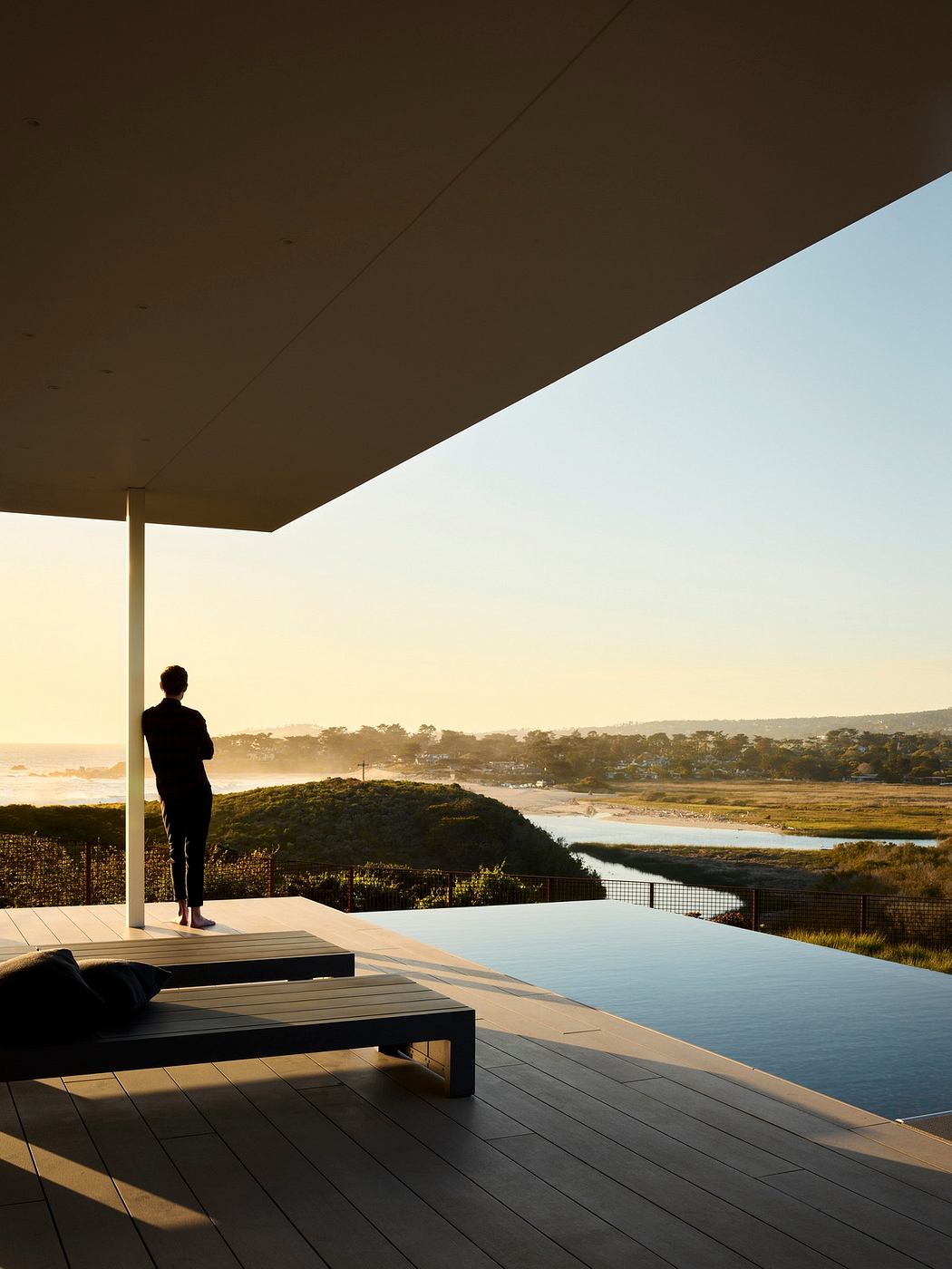 Sleek, minimalist porch design with a stunning view of the lush, rolling landscape.
