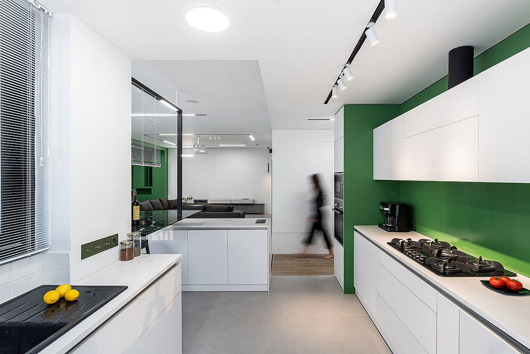 Sleek, minimalist kitchen with clean lines, contrasting green accent wall, and modern appliances.
