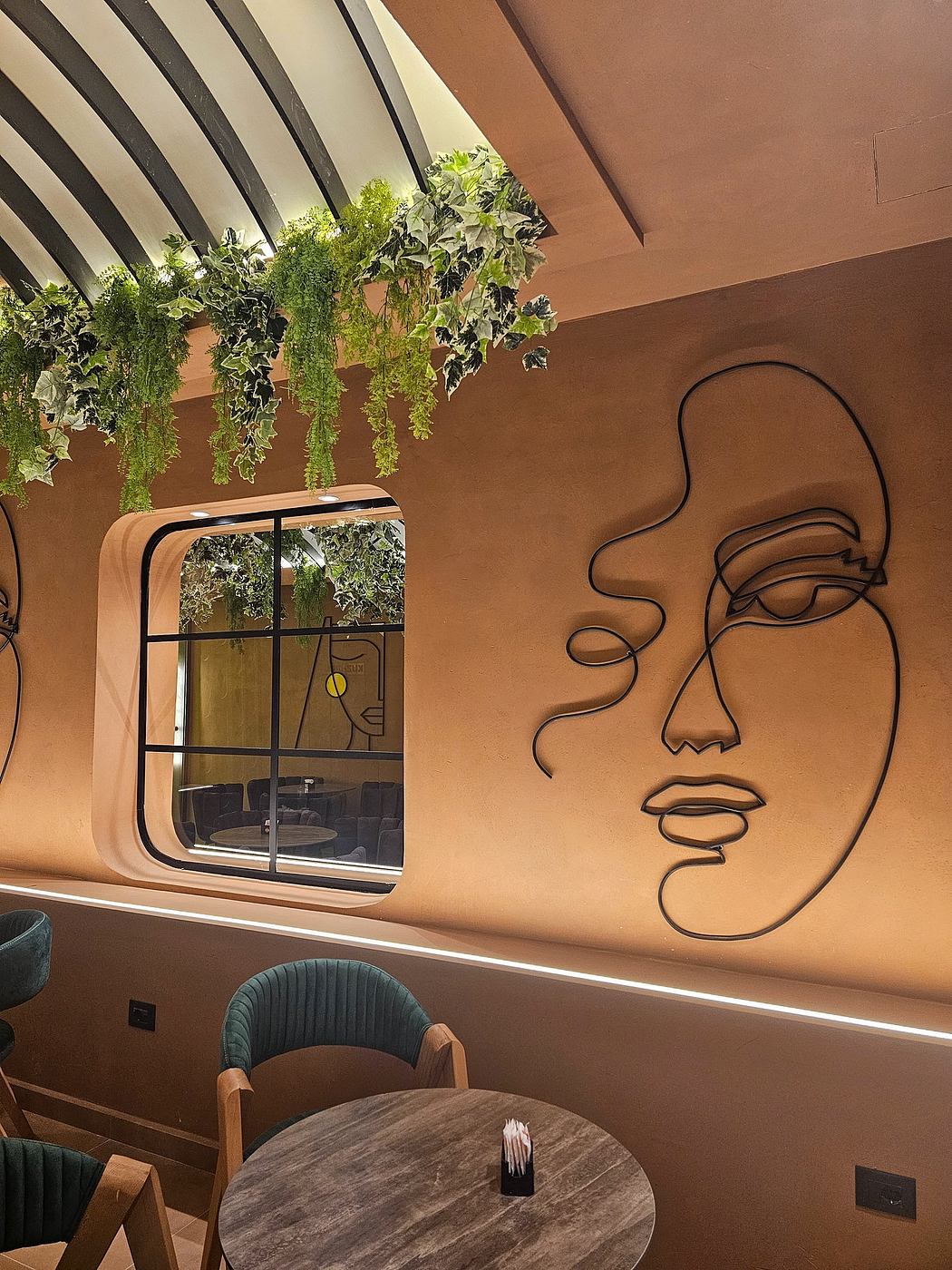 A cozy interior with stylized wall art, lush greenery, and modern furnishings.